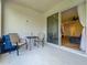 Covered patio with outdoor seating; view into the living area through sliding glass doors at 124 Juno Dr, Groveland, FL 34736