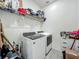 This practical laundry room features a modern washer and dryer and lots of storage space at 124 Juno Dr, Groveland, FL 34736