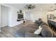 Spacious living room with hardwood floors, a large sectional sofa and an open layout at 124 Juno Dr, Groveland, FL 34736