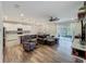 Open living area featuring hardwood floors, a comfortable sofa and access to the outdoor patio at 124 Juno Dr, Groveland, FL 34736