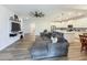 Cozy living room with hardwood floors, a large sectional sofa and an open layout at 124 Juno Dr, Groveland, FL 34736
