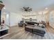 Comfortable living room showcasing a plush gray sectional sofa and ceiling fan at 124 Juno Dr, Groveland, FL 34736