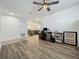 Inviting living space with an open floor plan, featuring hard wood floors and modern furnishings at 124 Juno Dr, Groveland, FL 34736