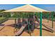 A close-up view of the playground features multiple slides, climbing structures, and a protective canopy at 124 Juno Dr, Groveland, FL 34736
