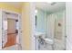 Bright bathroom featuring a pedestal sink, shower with curtain, and tile flooring at 1282 Fort Lawn Loop, The Villages, FL 32162