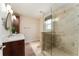Bathroom features double vanity, frameless glass shower, tile floor, and lots of natural light at 1282 Fort Lawn Loop, The Villages, FL 32162