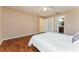 Comfortable bedroom featuring hardwood floors, neutral paint, ceiling fan and ensuite bathroom at 1282 Fort Lawn Loop, The Villages, FL 32162
