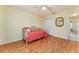 Bedroom with ceiling fan, daybed, and a closet down the hall for extra space at 1282 Fort Lawn Loop, The Villages, FL 32162