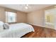 Bedroom with hardwood floors, lots of light from the windows, and neutral walls at 1282 Fort Lawn Loop, The Villages, FL 32162