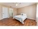 Cozy bedroom with wood floors, neutral tones, and easy access to a bathroom and closet at 1282 Fort Lawn Loop, The Villages, FL 32162