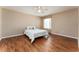 Inviting bedroom featuring wood floors, natural light, and simple decor for relaxation at 1282 Fort Lawn Loop, The Villages, FL 32162