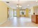 Bright dining and living area featuring tile floors and a view of the front yard at 1282 Fort Lawn Loop, The Villages, FL 32162