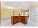 Open concept kitchen island leading into a spacious dining and living area with tile floors at 1282 Fort Lawn Loop, The Villages, FL 32162