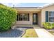 Inviting front entrance with a decorative glass door, lush landscaping, and elegant exterior lighting at 1282 Fort Lawn Loop, The Villages, FL 32162