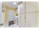 Laundry room with a full-size washer and dryer, overhead shelving, and plenty of cabinet space at 1282 Fort Lawn Loop, The Villages, FL 32162