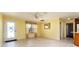 Bright living room with neutral tile flooring, skylights, and a door leading to the exterior at 1282 Fort Lawn Loop, The Villages, FL 32162
