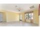 Bright living room with neutral tile flooring, skylights, and a door leading to the exterior at 1282 Fort Lawn Loop, The Villages, FL 32162