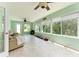 Bright sunroom featuring tile floors, three ceiling fans and large windows providing plenty of natural light at 1282 Fort Lawn Loop, The Villages, FL 32162