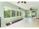 Sunroom featuring tile floors, plenty of windows for great natural light and a ceiling fan at 1282 Fort Lawn Loop, The Villages, FL 32162
