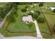 Desirable property featuring a pool, well-manicured lawns, and mature trees at 12913 County Road 104B, Oxford, FL 34484