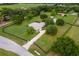 Attractive home featuring a pool, lush landscaping, and a long driveway at 12913 County Road 104B, Oxford, FL 34484