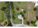 Expansive property with a beautiful home, pool, lush landscaping, and ample space for outdoor activities at 12913 County Road 104B, Oxford, FL 34484