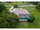 Bird's-eye view of home with backyard pool and lush landscaping in quiet neighborhood at 12913 County Road 104B, Oxford, FL 34484