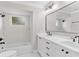 Bathroom with white shower and cabinets, light countertops, and modern black fixtures at 12913 County Road 104B, Oxford, FL 34484