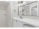 Bathroom featuring a single vanity, modern mirror and fixtures, and a shower behind glass at 12913 County Road 104B, Oxford, FL 34484