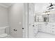 Bathroom showcasing a white toilet, door with black hardware, and a vanity area with modern fixtures at 12913 County Road 104B, Oxford, FL 34484