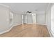 Spacious bedroom with wood-look floors featuring ensuite bathroom and multiple entry doors at 12913 County Road 104B, Oxford, FL 34484