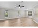 Bright bedroom with plenty of natural light from multiple windows and wood look flooring at 12913 County Road 104B, Oxford, FL 34484