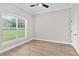 A serene bedroom with hardwood floors, a ceiling fan, and natural light at 12913 County Road 104B, Oxford, FL 34484