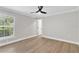 Bedroom with natural light, a ceiling fan, wood laminate flooring, and neutral walls at 12913 County Road 104B, Oxford, FL 34484