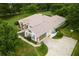 Attractive home featuring a long driveway, lush landscaping, and an attached garage at 12913 County Road 104B, Oxford, FL 34484