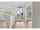 Bright foyer with wood flooring and French doors leading to a landscaped backyard at 12913 County Road 104B, Oxford, FL 34484
