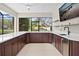 Outdoor kitchen featuring a white countertop, stainless steel mini fridge, and a sink at 12913 County Road 104B, Oxford, FL 34484