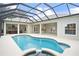 Screened-in pool, outdoor kitchen, and covered patios create a private backyard retreat at 12913 County Road 104B, Oxford, FL 34484