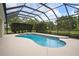 Screened-in pool with surrounding patio and green landscaping at 12913 County Road 104B, Oxford, FL 34484