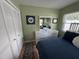 Bedroom with a bed with blue bedding, dresser, and closet at 1339 Orchid Ave, Winter Park, FL 32789
