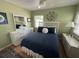 Green bedroom featuring a bed with blue bedding, a ceiling fan, and a window at 1339 Orchid Ave, Winter Park, FL 32789