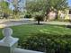 Lush front yard featuring a vibrant green lawn, decorative palm tree, and a colorful flowerbed at 1339 Orchid Ave, Winter Park, FL 32789