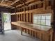 Unfinished garage with a concrete floor, wood framing, workbench and a door that leads to the exterior at 1339 Orchid Ave, Winter Park, FL 32789