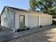 Spacious two-car garage with a green door, surrounded by meticulous landscaping and a concrete driveway at 1339 Orchid Ave, Winter Park, FL 32789