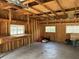 An unfinished two-car garage with a concrete floor, exposed wood frame and multiple windows for natural light at 1339 Orchid Ave, Winter Park, FL 32789