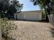 Large two-car garage featuring an expansive driveway and a green door that matches the home's trim at 1339 Orchid Ave, Winter Park, FL 32789