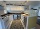 Charming kitchen with white cabinets, stainless steel appliances, and unique glass block accent at 1339 Orchid Ave, Winter Park, FL 32789