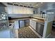 Efficient kitchen with white cabinets, stainless dishwasher, and glass block feature at 1339 Orchid Ave, Winter Park, FL 32789