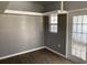 A bright living space features wood floors, a window and a glass panel door providing entry to the exterior at 1339 Orchid Ave, Winter Park, FL 32789