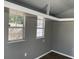Living space boasts wood floors, gray walls, white trim and two windows that allow plenty of light at 1339 Orchid Ave, Winter Park, FL 32789